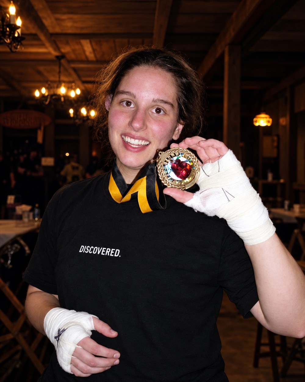 Nora Martin holding her Golden Gloves boxing medal